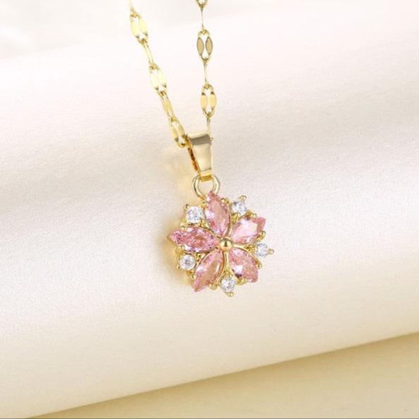 Gold-tone chain cherry blossom pendant with pink crystal petals and clear round stones