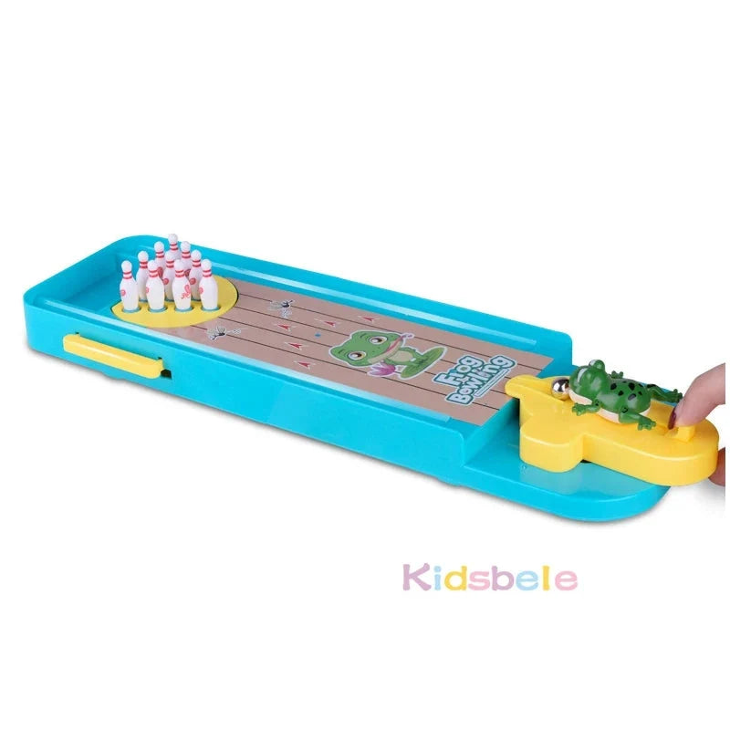 Mini desktop bowling game tray with standing pins, green frog figure, and ramp launcher
