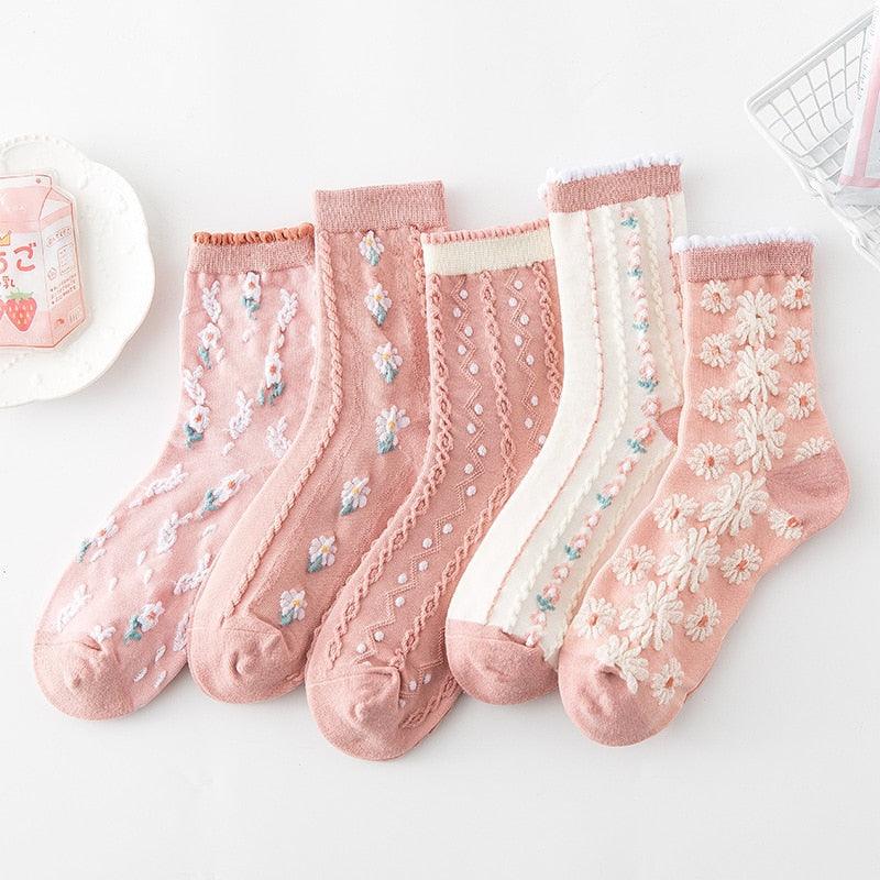Floral embroidered socks in pink and white, with small blue and green flower motifs