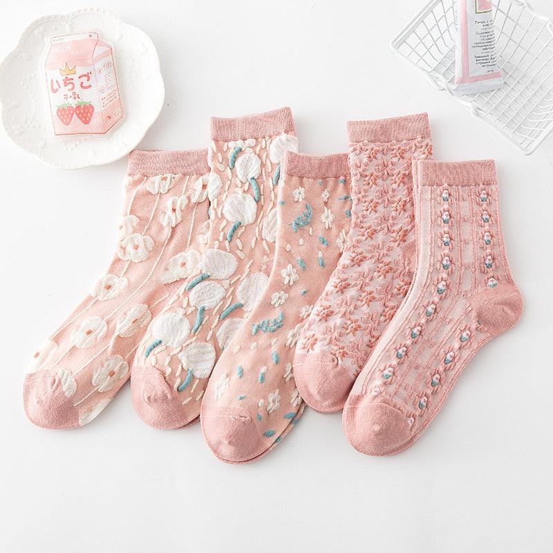 Floral embroidered socks in pink, with white daisies and blue-green sprig accents