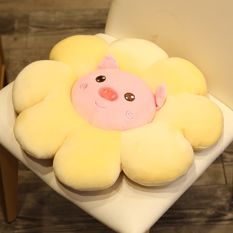 Yellow plush flower pillow with pig face and small brown eye and rosy cheek details