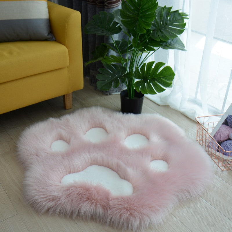 Light pink faux fur cat paw area rug with lighter pink pad shapes