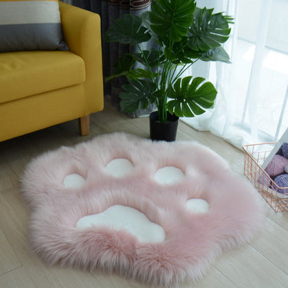 Light pink faux fur cat paw area rug with lighter pink pad shapes