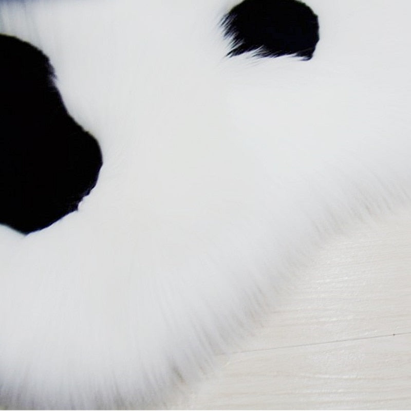 Plush cat paw area rug with black paw prints on white pile