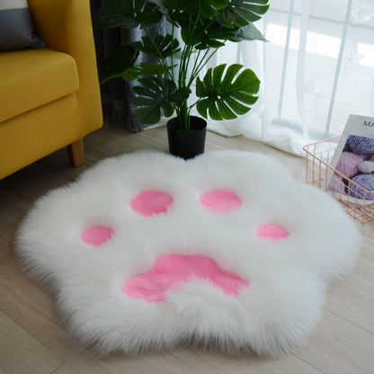 White faux fur round cat paw area rug with pink paw pad details