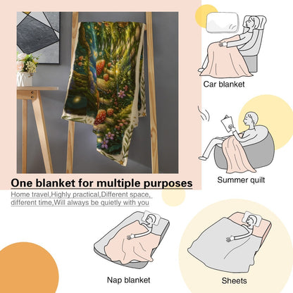 Enchanted forest throw blanket with decorative border, mushrooms, and soft green-blue artwork