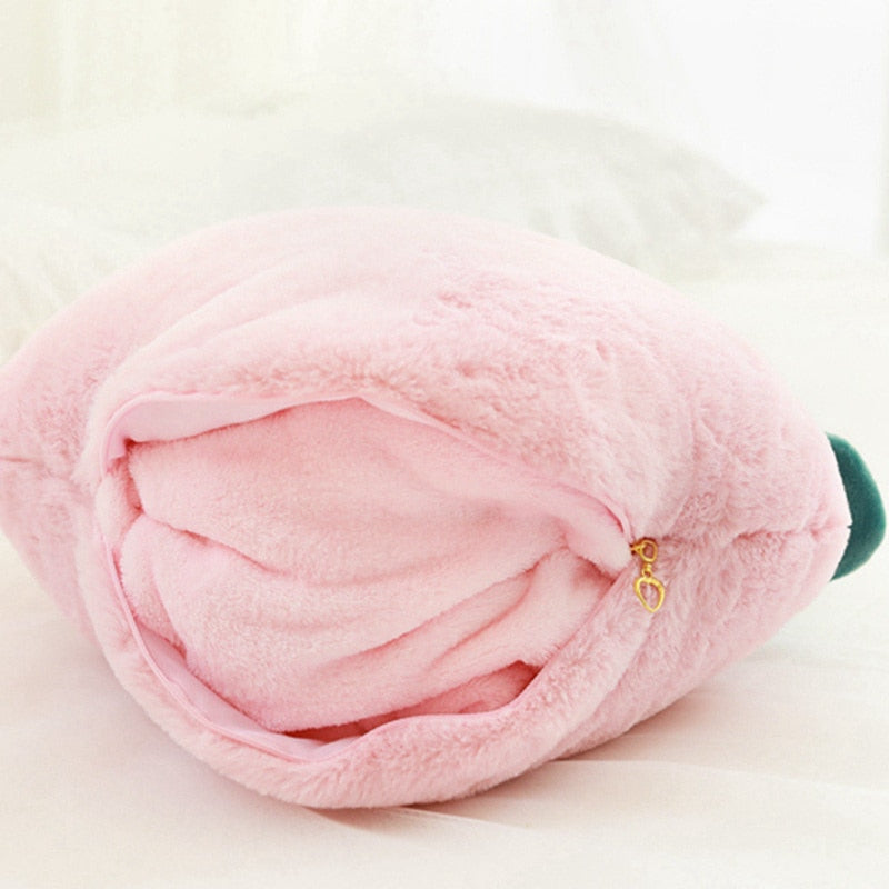 Rolled pink plush peach pillow blanket with green leaf and gold charm zipper