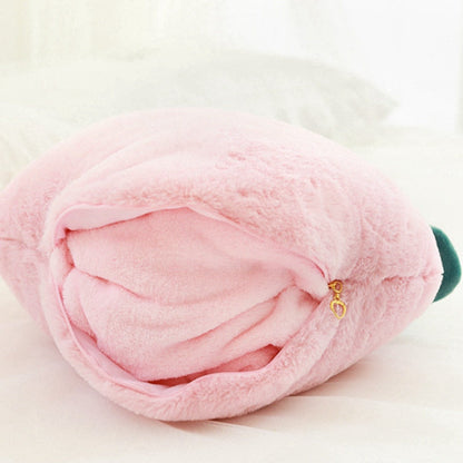 Rolled pink plush peach pillow blanket with green leaf and gold charm zipper
