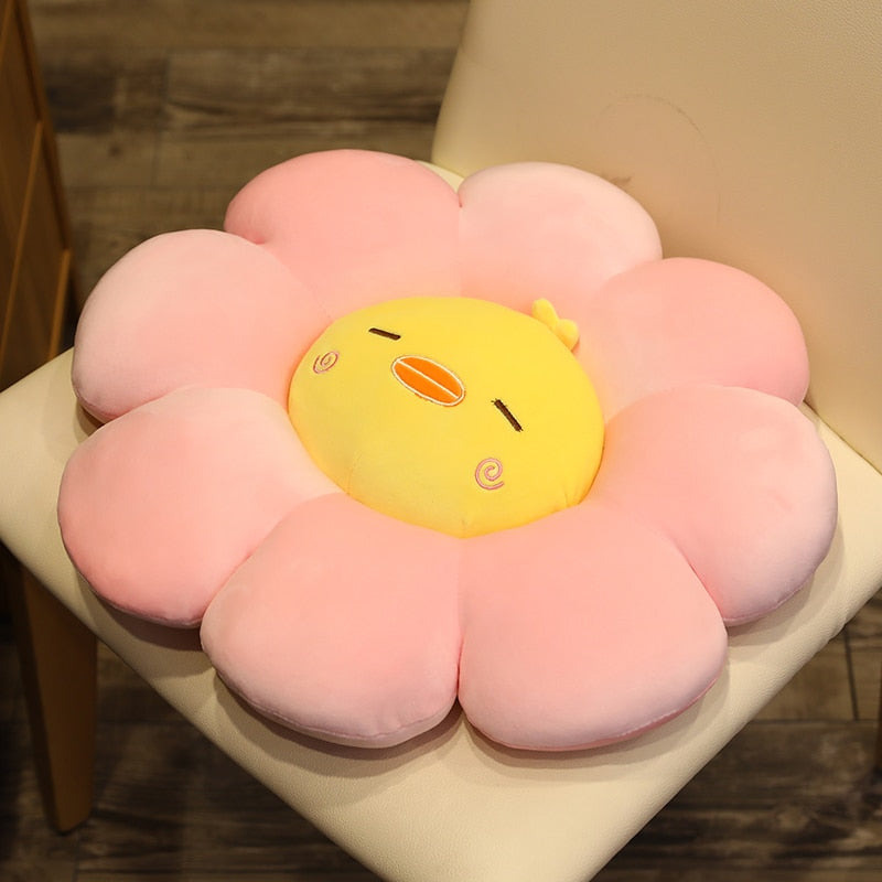 Pink plush flower pillow with yellow chick face and small oval beak and eye details