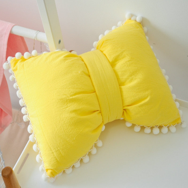 Bright yellow bow decorative pillows with pom pom trim, two-piece set