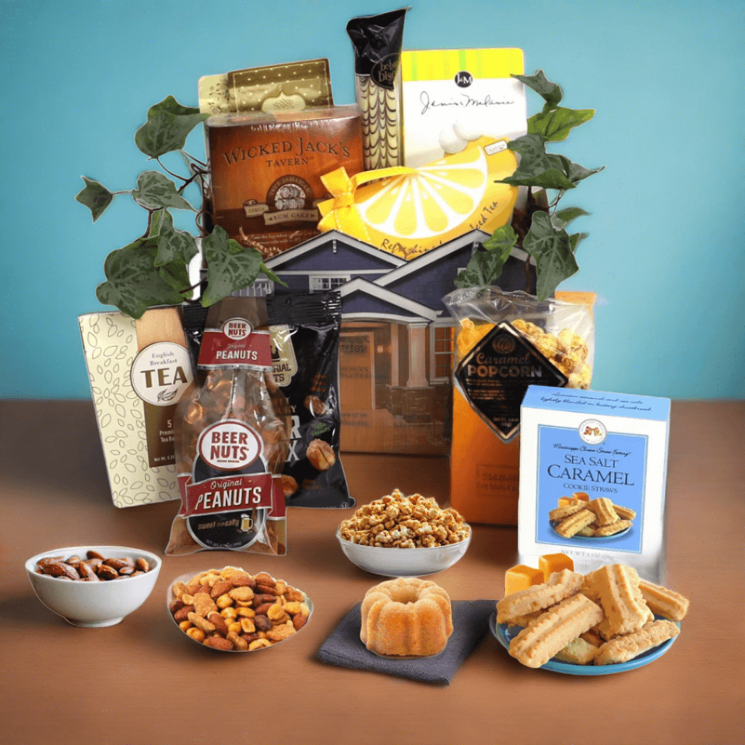 Gift basket with house-shaped box of snacks, tea, peanuts, caramel cookies