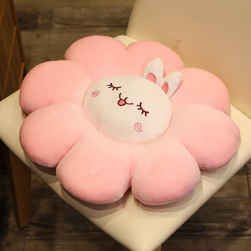 Light pink plush flower pillow with white bunny face and stitched ear details