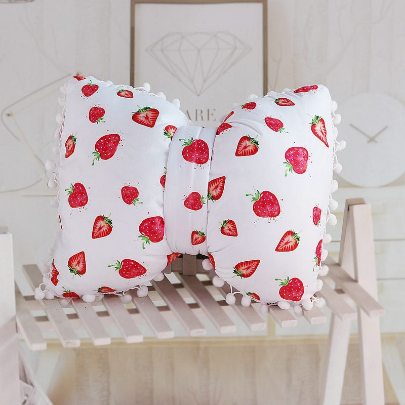 White bow decorative pillows with strawberry print and pom pom trim, two-piece set