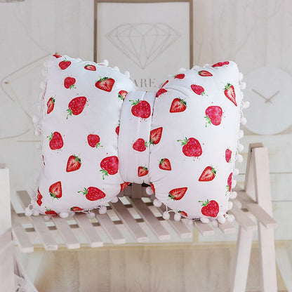 White bow decorative pillows with strawberry print and pom pom trim, two-piece set
