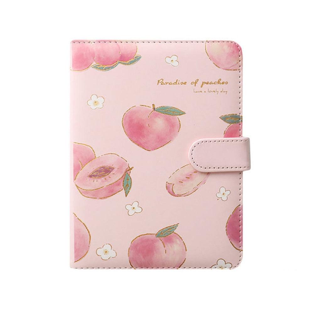 Peach-themed notebook cover with multiple peaches pattern and a white snap strap