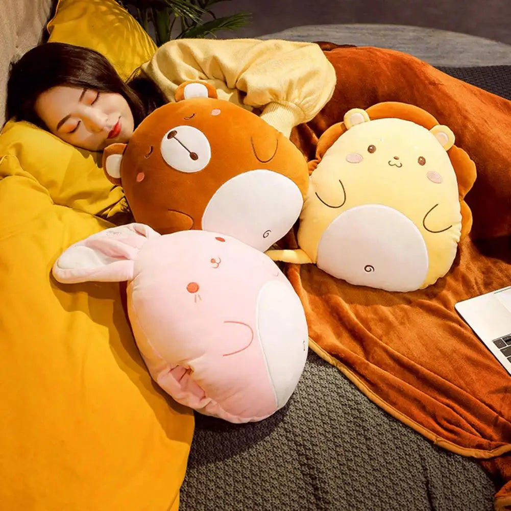 Plush animal cushion blankets on a bed: orange bear, light-pink rabbit, and mint-green dinosaur
