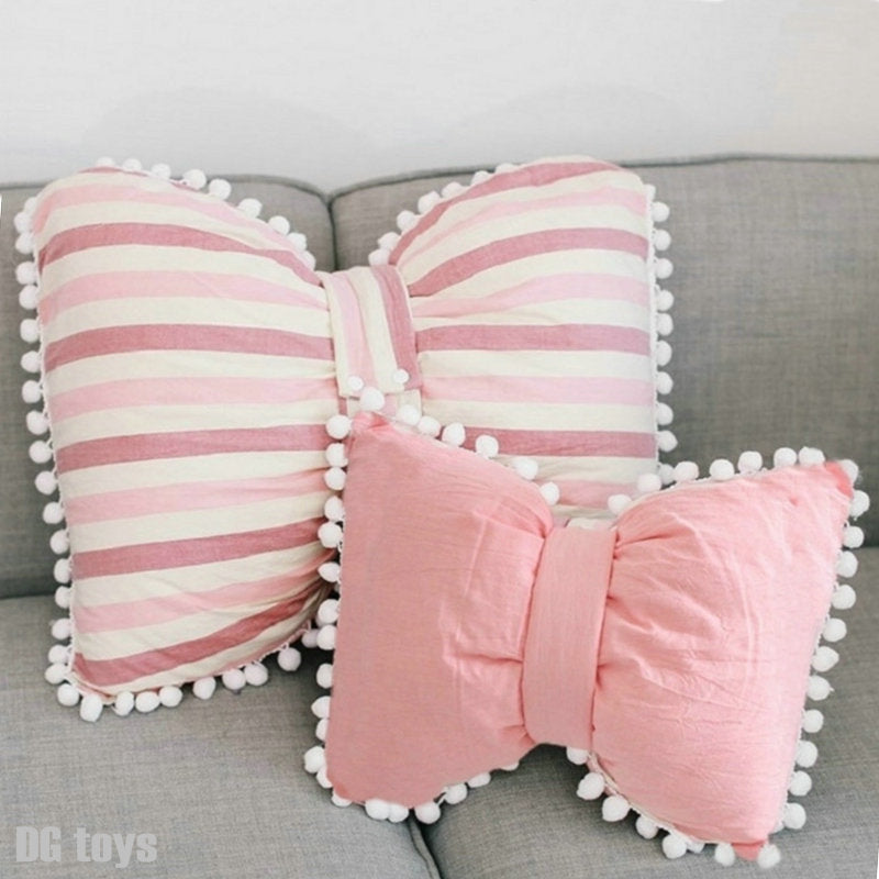 Pink and white striped bow decorative pillows with pom pom trim, set of two