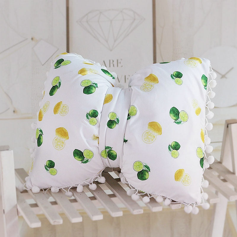 White bow decorative pillows with lemon print and pom pom trim, two-piece set