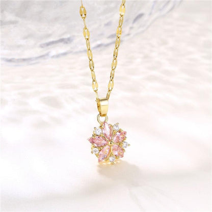 Gold-tone floral pendant necklace with pink flower center and clear crystal accents