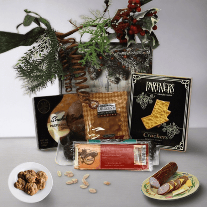 Classic holiday gift box with crackers and cheese spread, decorated with greenery top.