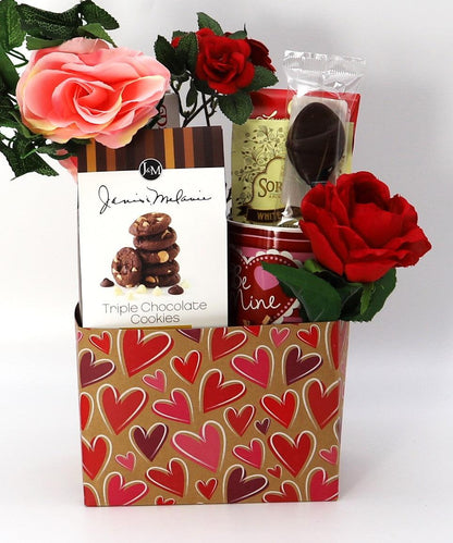 Valentine gift box with heart-pattern wrapping, red and pink roses, and chocolate gifts