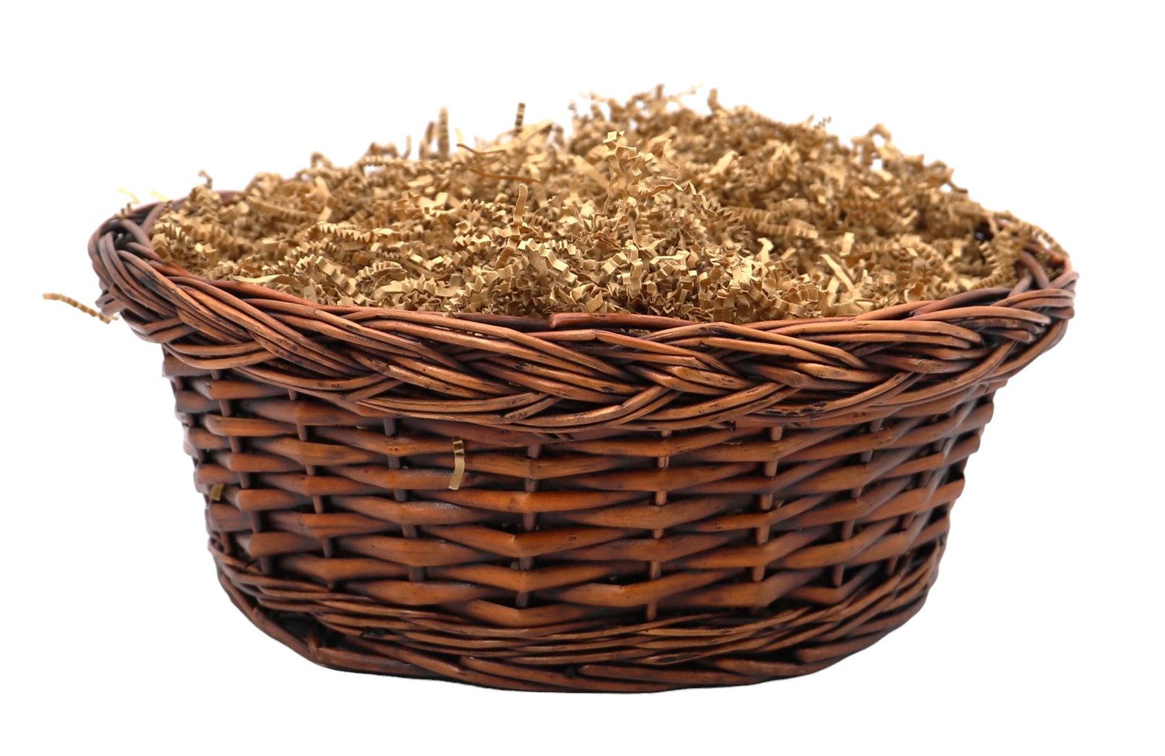 Brown wicker basket lined with shredded filler for gift presentation