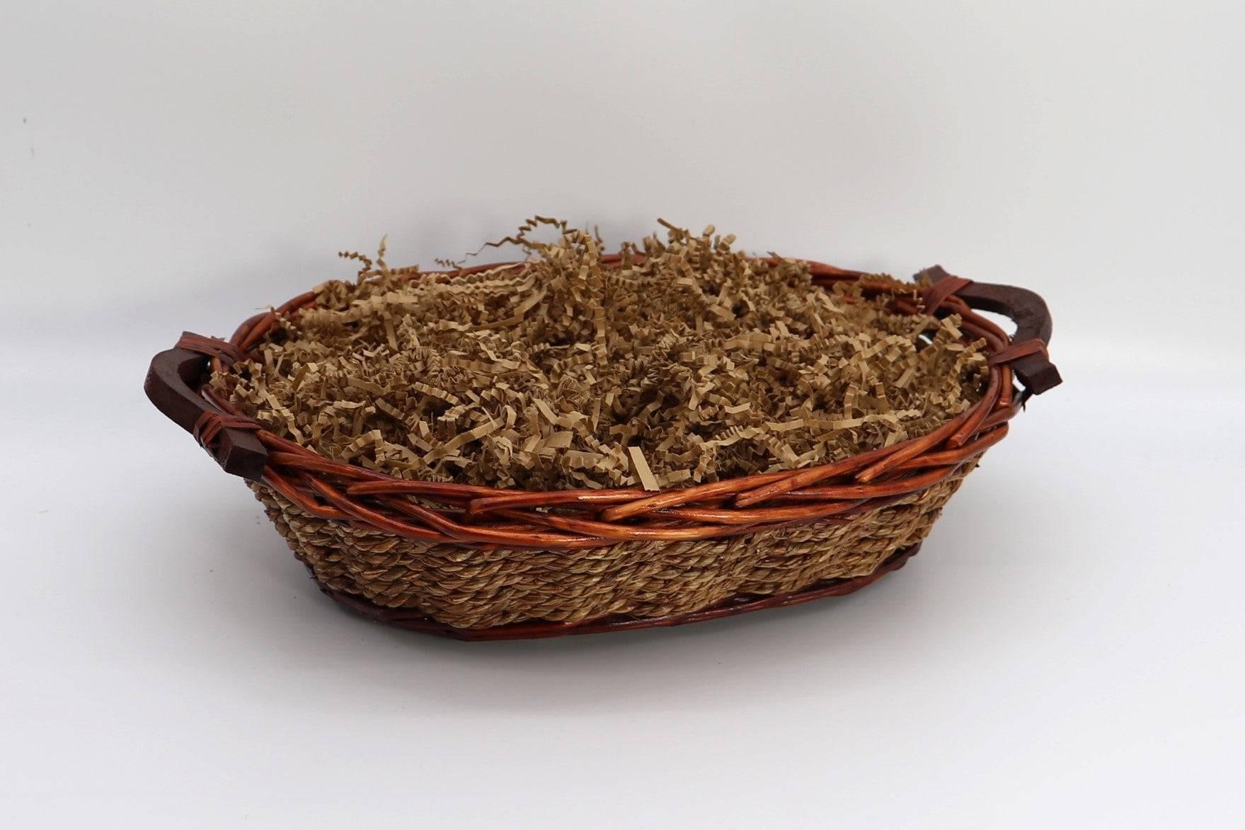 Wicker gift basket filled with brown shredded paper filler