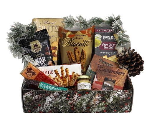 Holiday gourmet gift basket with pine garland trim, showing mixed sweets and crackers