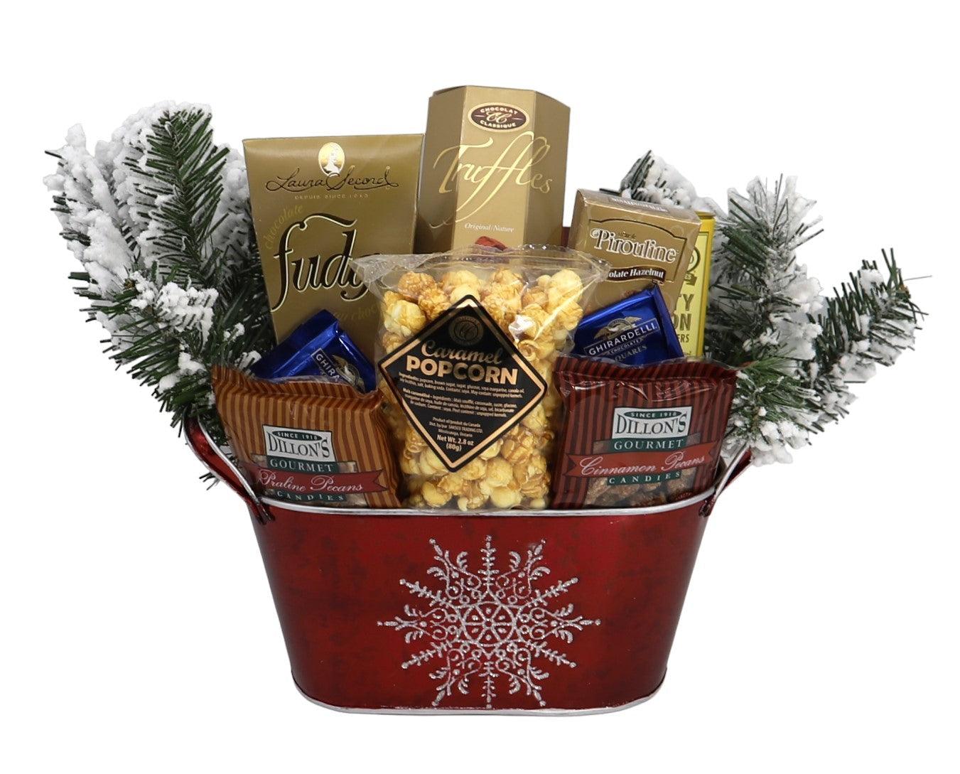 Red snowflake gift basket with truffles, popcorn, pretzels, and candy
