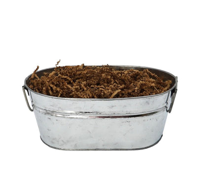 Silver metal bucket filled with shredded brown filler