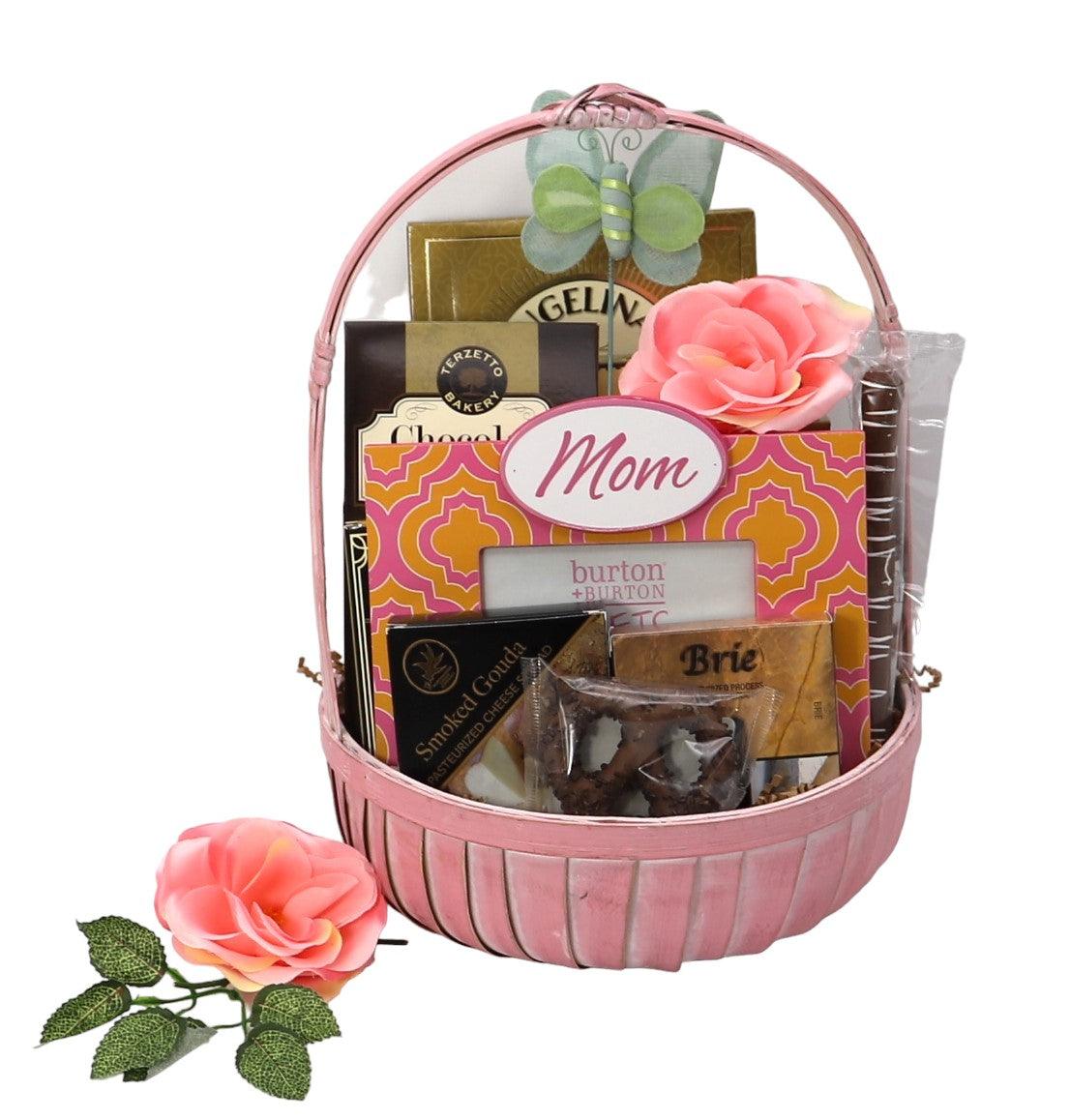 Mother’s gift basket with pink handle and floral topper, filled with chocolate treats