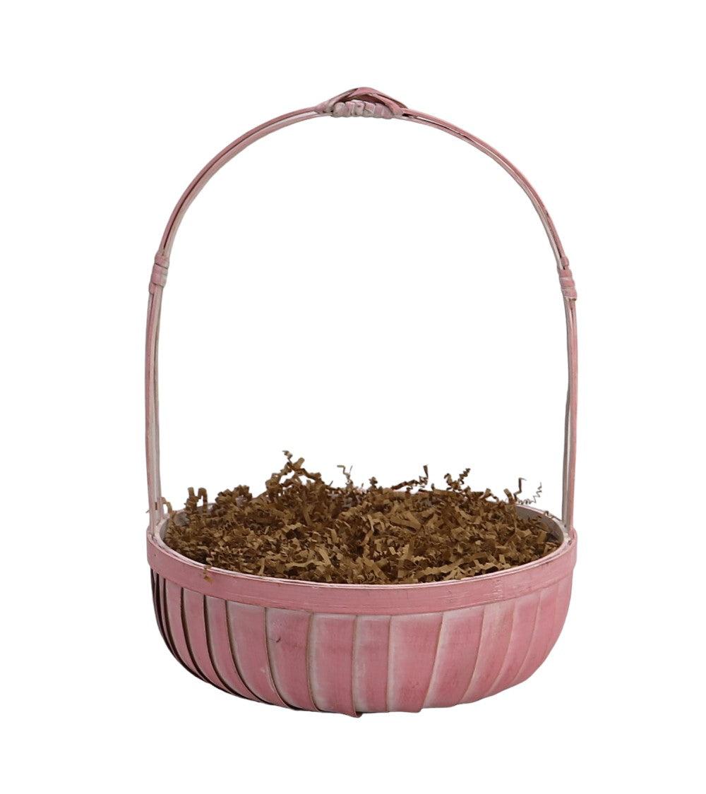 Mother’s gift basket with pink handle, filled with shredded filler and treats