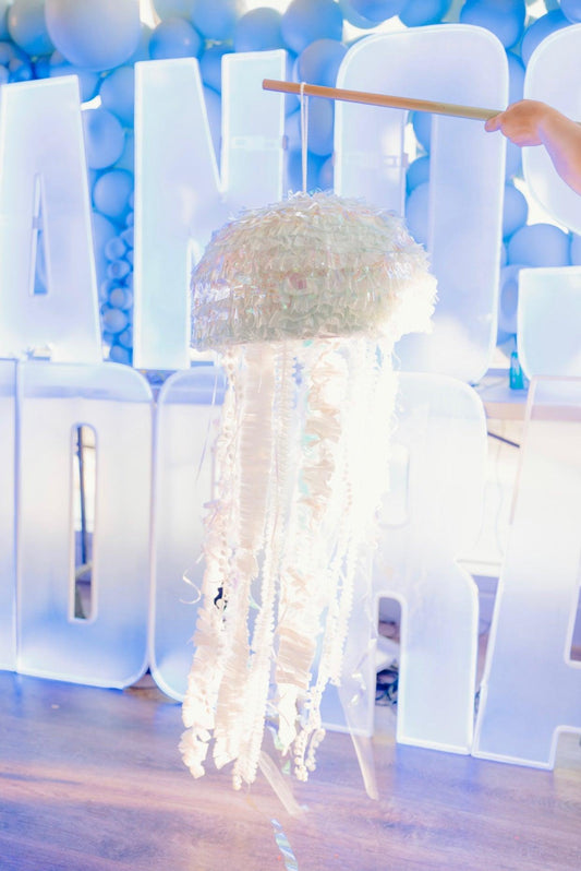 Jellyfish piñata with hanging rod and layered iridescent tissue canopy, pastel blue