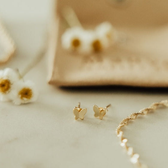 Pair of gold butterfly mini studs with smooth, flat wings