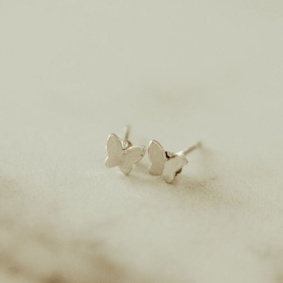 Pair of silver butterfly mini stud earrings with flat wings