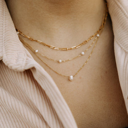 Melbourne Pearl Necklace layered with gold chains and small pearl accents