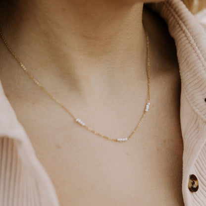Fine gold-tone necklace with small white pearl accents