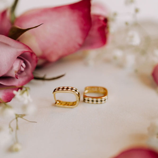 Times Square reversible hoop earrings with gold-tone bands and dark diamond accents