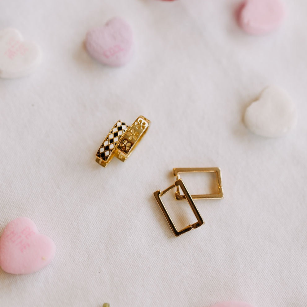 Reversible gold hoop earrings shown with patterned sides and plain backs