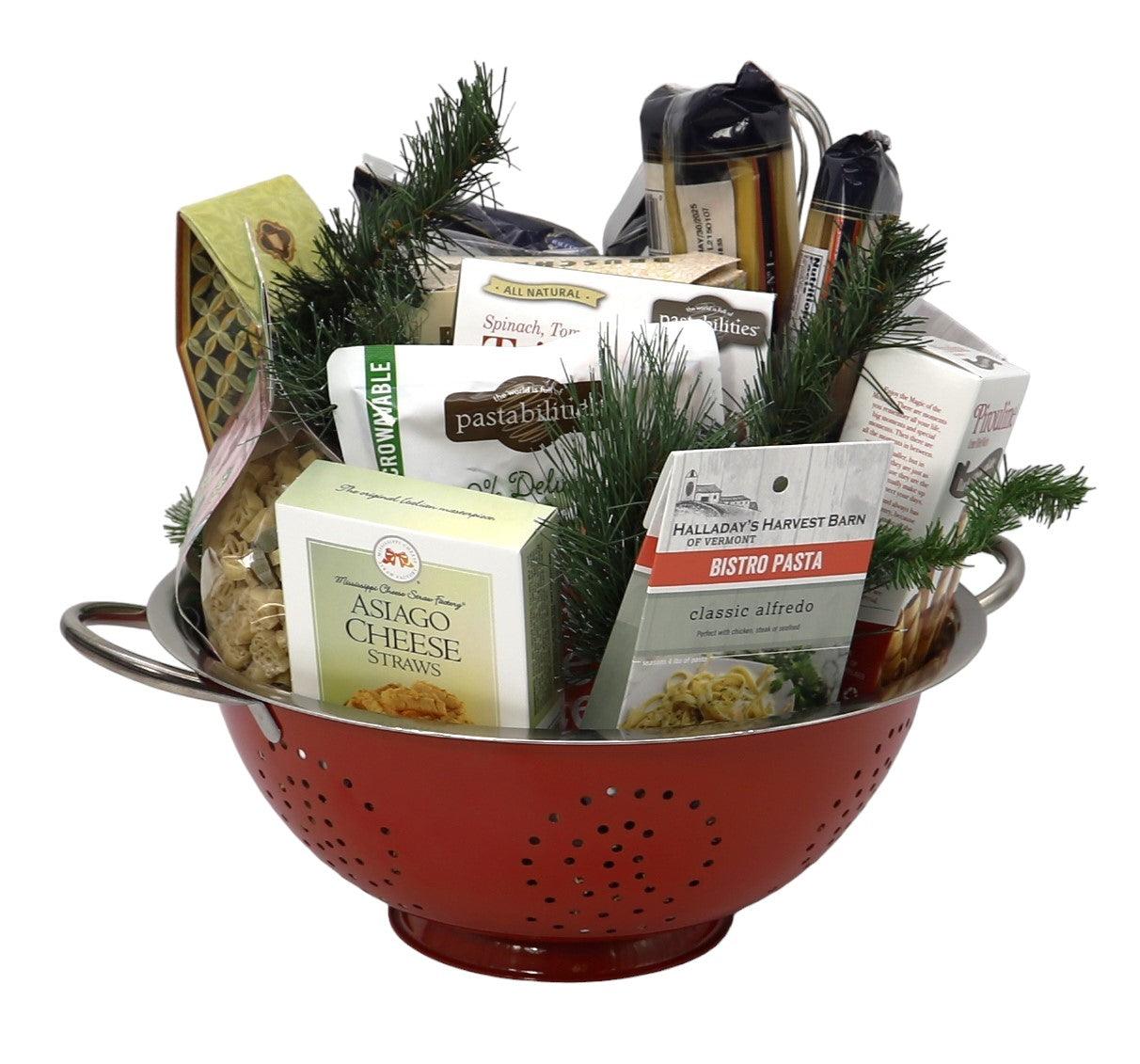 Red colander-style gift basket filled with pasta, cheese, and gourmet pantry items