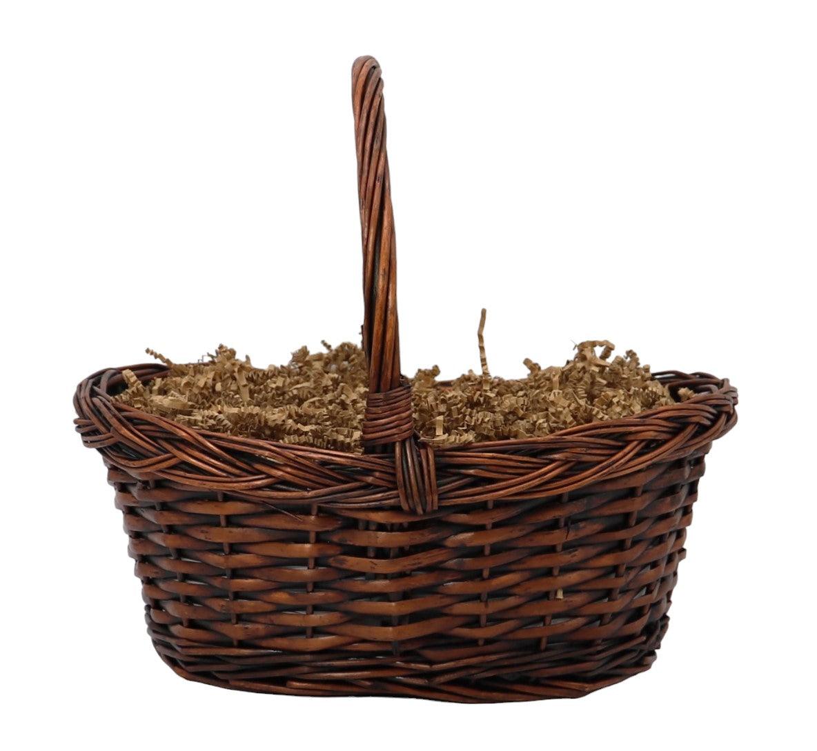 Woven wicker gift basket with tall handle and crinkle paper filler