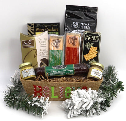 Medium gift basket with BELIEVE lettering, assorted snacks, greenery and white snow accents