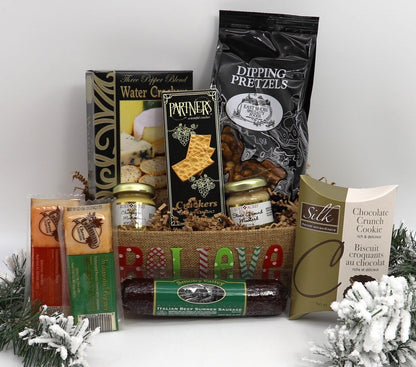 Medium gift basket with assorted packaged snacks, faux foliage and faux snow decor