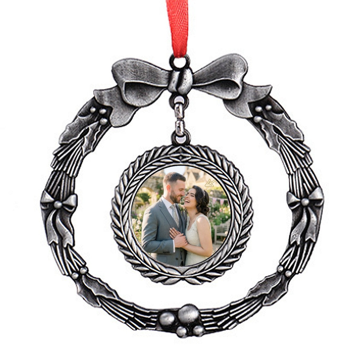 Silver wreath-style photo ornament with bow, red ribbon, and round portrait frame