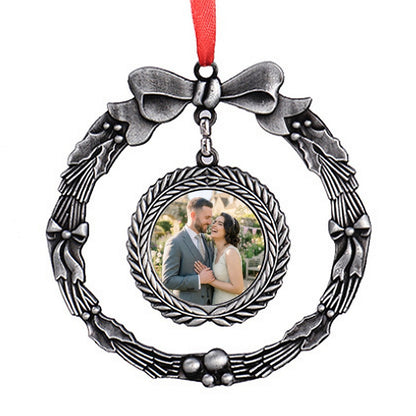 Silver wreath-style photo ornament with bow, red ribbon, and round portrait frame