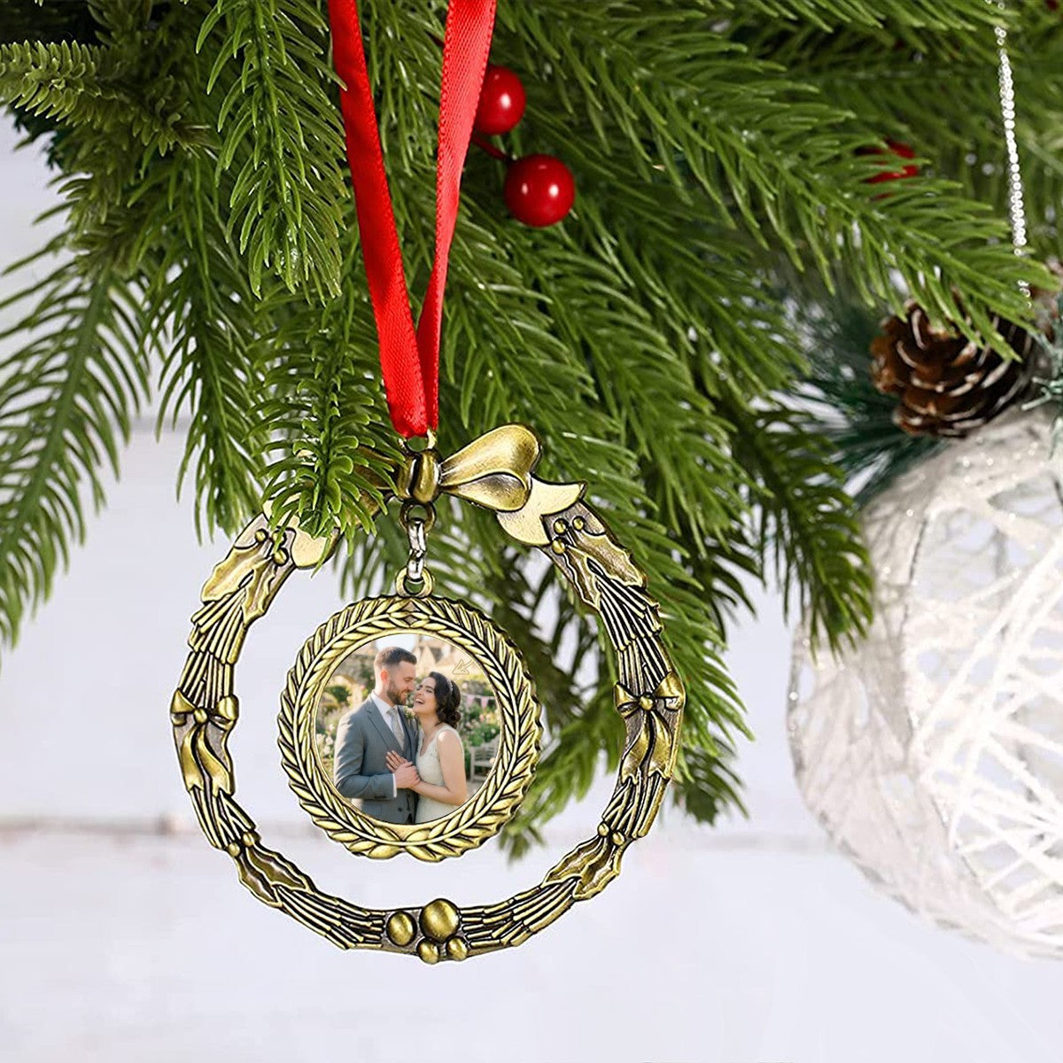 Golden wreath photo ornament with bow and portrait medallion on a red ribbon
