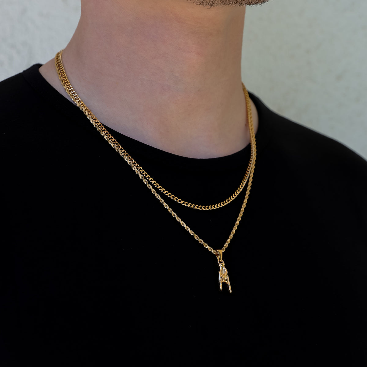 Gold layered necklace set with small horn-hand pendant