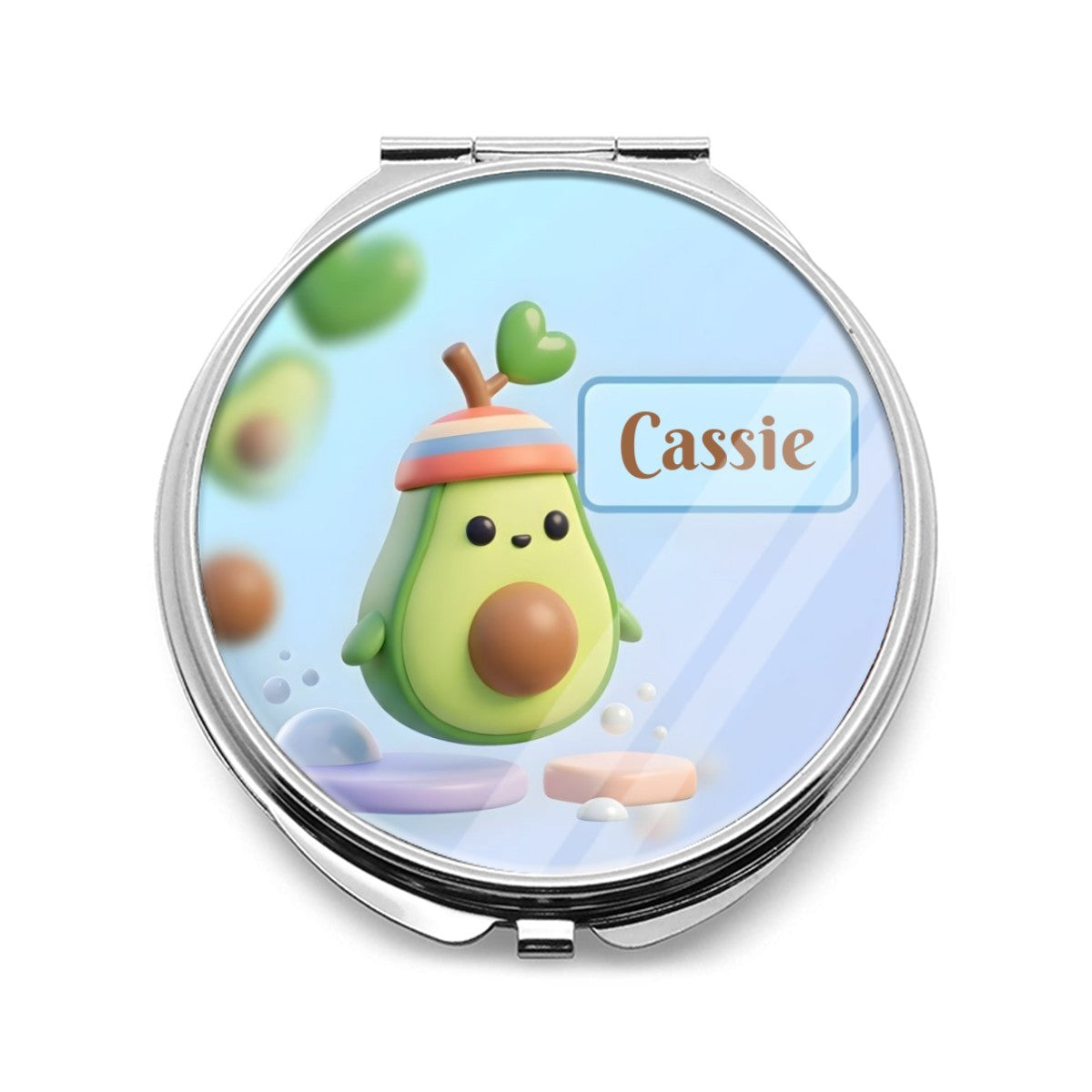 Silver compact mirror with a colorful avocado character and Cassie name on the lid