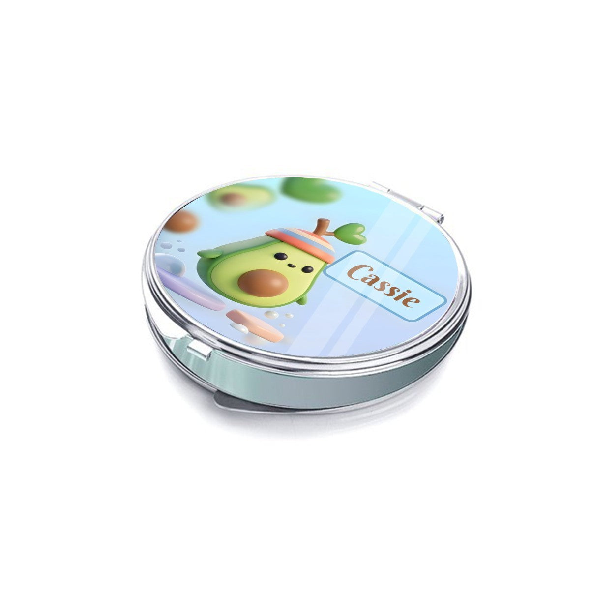 Closed silver compact mirror showing an avocado character and Cassie name on the lid