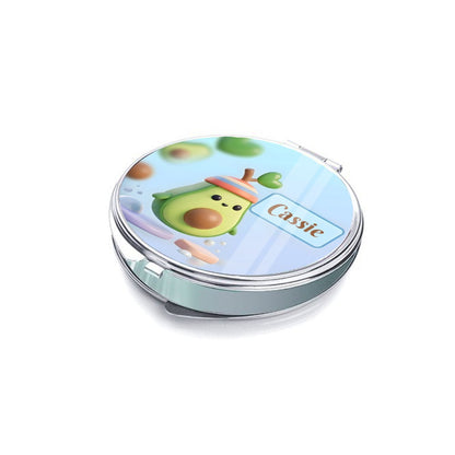 Closed silver compact mirror showing an avocado character and Cassie name on the lid